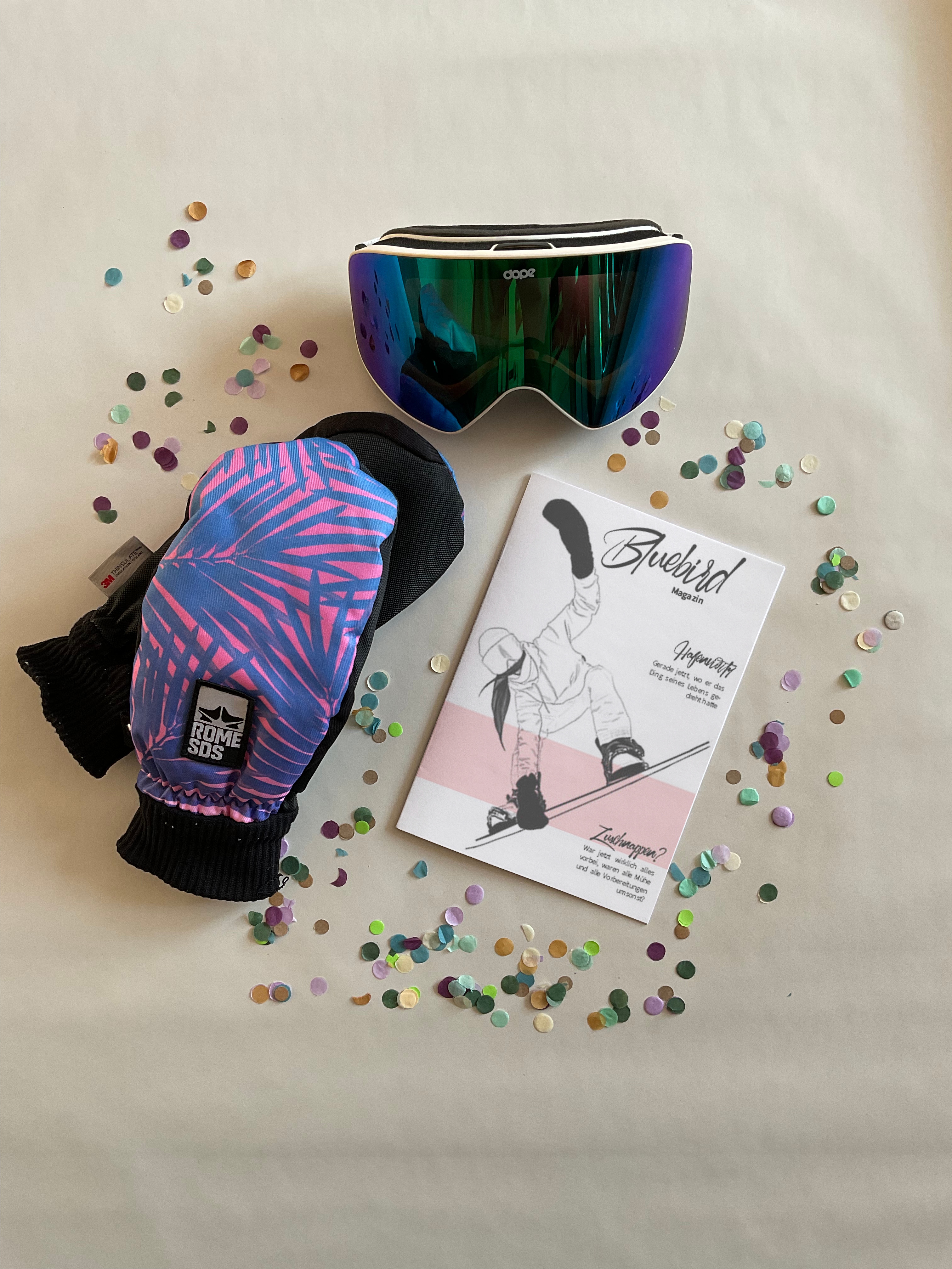 Broschüre, Handschuhe und Snowboardbrille mit Konfetti